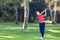 Young golf player hits a driver shot from the tee on a golf course. Concept: competition, concentration, sport, wealthy life.