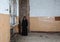 Young goth woman stands in the room of an abandoned house