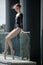 Young graceful ballerina in black bathing suit on