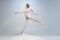 Young and graceful ballet dancer, ballerina dancing in image of angel with wings  on gray studio background. Art