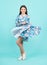 Young graceful teenager child in dress  on blue background. Beautiful teen in summer clothing. Happy teenager