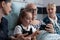 Young granddaughter, grandfather playing cell phone video games