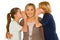 young grandmother with nephew and niece standing on white background