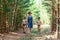 Young grandmother walks in the woods with two grandchildren
