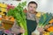 Young grocery clerk posing in produce aisle grocery store