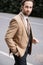 young groom in beige formal wear