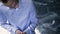 Young groom in blue shirt buttoning in wedding day indoors.