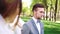 Young groom looking at three beautiful brides walking around his