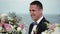 The young groom at the wedding ceremony stands at the altar of the arch and waits for the bride. Wedding by the sea