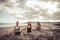 Young group beautiful women yoga practice on mat relaxation in class exercise with pose fitness sport for healthy on the beach and