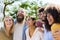 Young group of diverse friends having fun outdoors in a sunny day