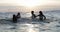 Young Group Of Friends Splashing In Sea At Sunset, Cheerful People Having Fun In Water On Beach During Summer Vacation