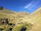 A young group of international hikers, led by their local Inca guide, navigate the Andes mountains on the way to the gorgeous Rain