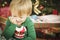 Young Grumpy Boy Sitting Near Christmas Tree