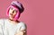 Young grunge style woman with pink hair in clear modern purple hat cap