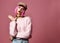 Young grunge style woman with pink hair in clear modern purple hat cap