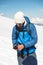 A young guide prepares crampons for use