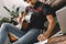 Young guitarist hipster at home sitting on the floor with guitar writing melody