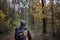 A young guy with a backpack in the hat, traveler, hipster standing in the woods, Hiking, Forest,Journey.Copy space