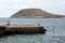 A young guy and a black heron on a stone of Magaluf beach meet the dawn. Loneliness. Sadness. Magaluf, Mallorca, Balearic Islands