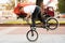 A young guy on a BMX bike, rides on the front wheel, braking with his foot