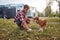 A young guy collects a poop of his dog while walking in the park. Friendship, walk, pets