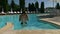 Young guy comes out of the pool after a swim