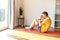 A young guy doing sit-ups exercise at home