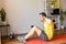 A young guy doing sit-ups exercise at home