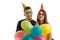 Young guy with a girl, holding near the eye paper glasses happily laughing and carrying balloons