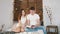 Young guy and girl sitting in a hug on the couch and reading a book