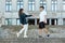 Young guy and a girl on the street. the guy holds the girl`s hand, and they take a step towards each other