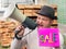A young guy in a hat shouts loudly in a megaphone informing people about the upcoming sale. In the hand of a man sign sale