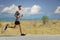 Young guy jogging in the countryside on an open road