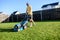 A young guy mows a lawn with a lawn mower