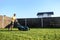 A young guy mows a lawn with a lawn mower