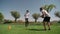 A young guy with a personal fitness trainer performs push-ups and resistance runs for endurance and body coordination