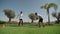 A young guy with a personal fitness trainer performs push-ups and resistance runs for endurance and body coordination