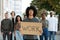 Young guy with placard leading anti-lockdown protest