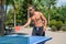 A young guy plays table tennis without shirts in a park on a background of palms in a tourist city