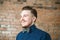 Young guy with pompadour haircut, dressed in blue shirt with a happy face. real photo hair for barbershop