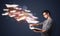 Young guy reading a book with flying sheets coming out of the bo