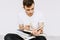 A young guy is reading books. A student, a schoolboy preparing to study. Isolated white background