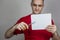 Young guy in a red t-shirt cuts a piece of paper