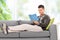 Young guy relaxing with a book at home