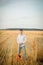 Young guy is relaxing in the countryside with a guitar. Plays the guitar . Resting lying on the hay