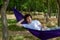 Young guy resting in a hammock in nature