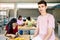 Young guy student man smiling at camera standing at electronic classroom