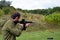 A young guy is trained in combat shooting from a rifle AR 15.