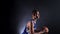 Young guy in the uniform of a basketball player posing in the studio on a black background in the light of a spotlight